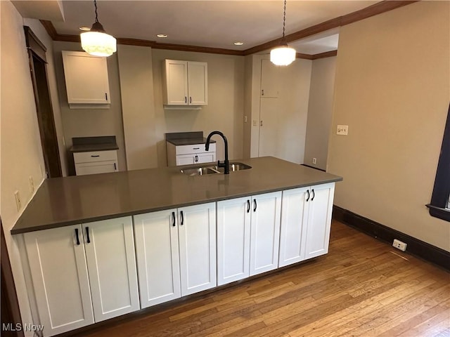 2572-2574 Mayfield Rd, Cleveland Heights, OH 44106 - kitchen featuring dark countertops, ornamental molding, white cabinets, wood finished floors, and pendant lighting