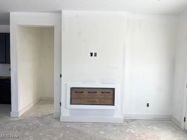 unfurnished living room featuring concrete floors