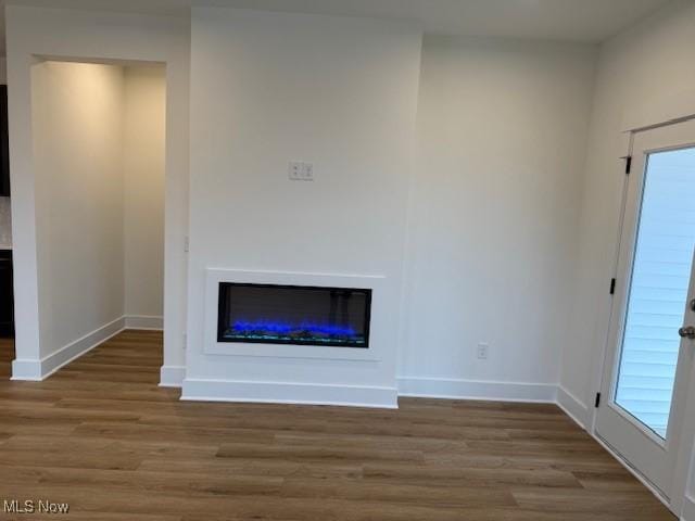 unfurnished living room featuring hardwood / wood-style floors