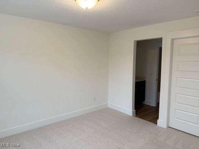 empty room featuring light colored carpet