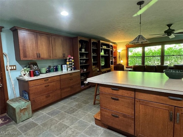 kitchen featuring pendant lighting and ceiling fan