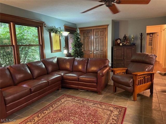 tiled living room with ceiling fan