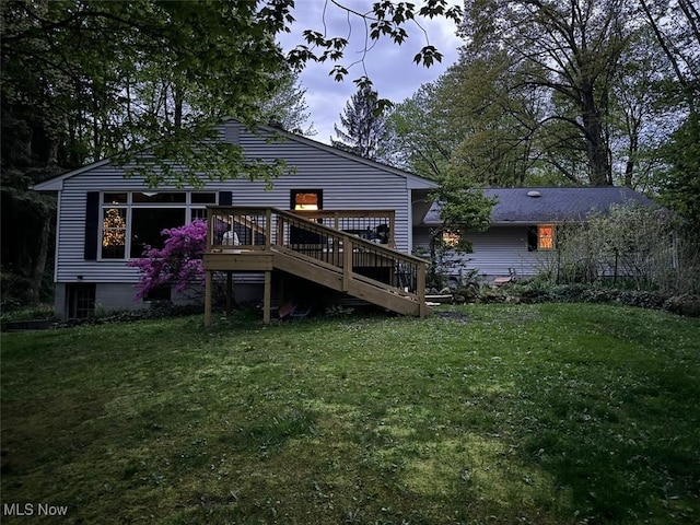 back of house featuring a wooden deck and a yard