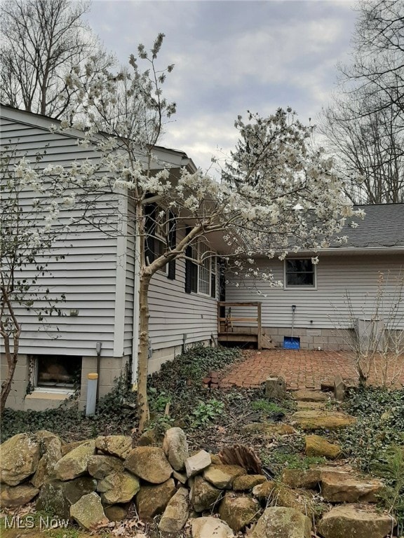 view of home's exterior featuring a wooden deck