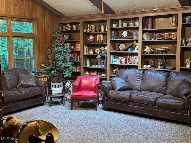 living room with carpet flooring, wooden walls, and vaulted ceiling with beams