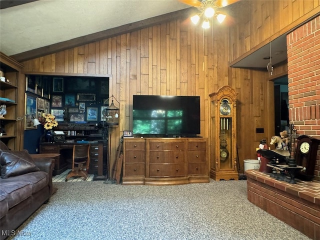 carpeted living room with ceiling fan, wood walls, and lofted ceiling