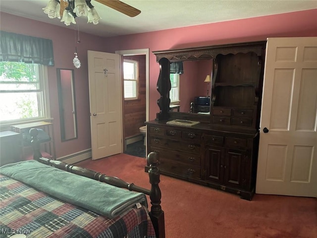 carpeted bedroom featuring ceiling fan and baseboard heating