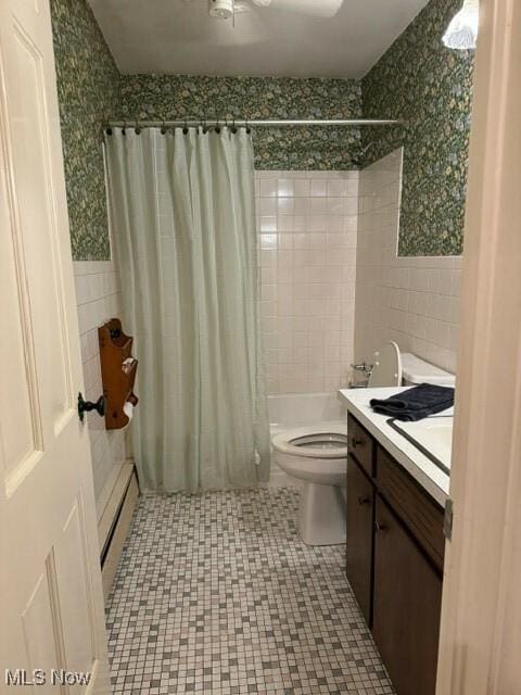 full bathroom with a baseboard radiator, tile walls, vanity, toilet, and shower / bathtub combination with curtain