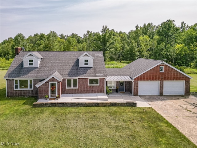 cape cod home with a garage and a front yard