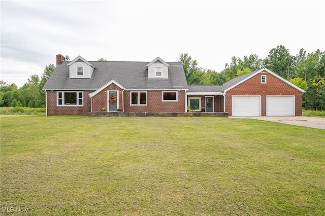 cape cod house featuring a front lawn and a garage