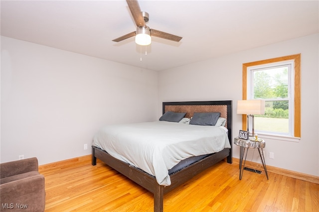 bedroom with light hardwood / wood-style flooring and ceiling fan