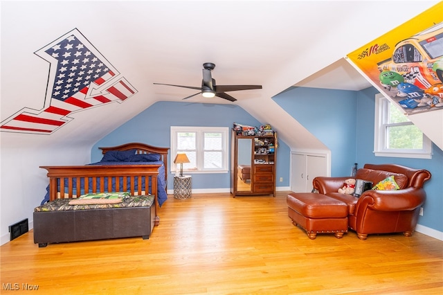 bedroom featuring ceiling fan, light hardwood / wood-style flooring, and lofted ceiling