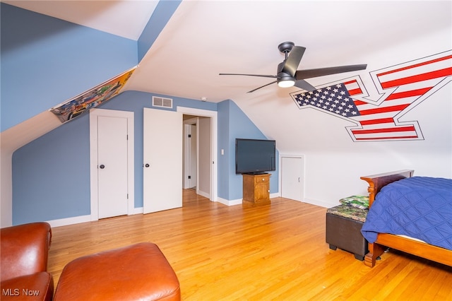 bedroom featuring ceiling fan, hardwood / wood-style flooring, and lofted ceiling