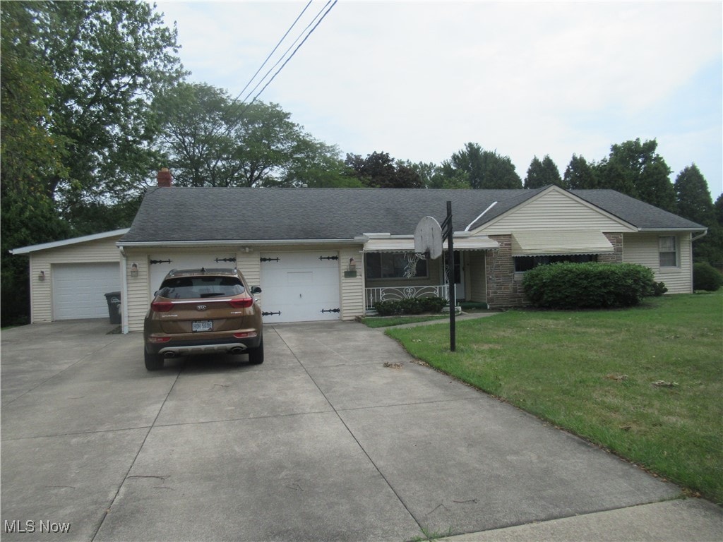 single story home featuring a garage and a front yard