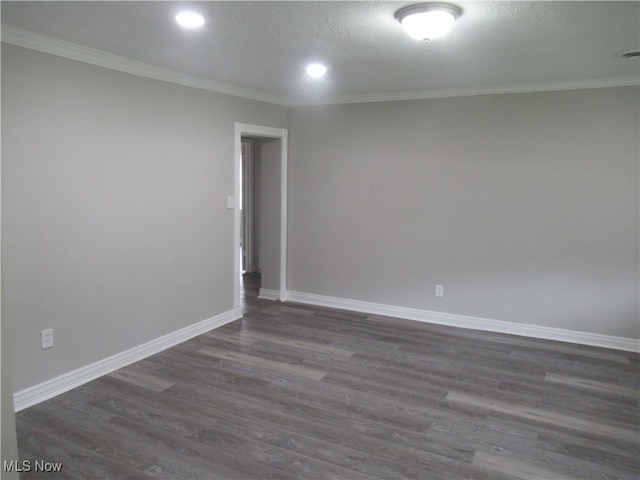 empty room featuring dark hardwood / wood-style floors, ornamental molding, and a textured ceiling