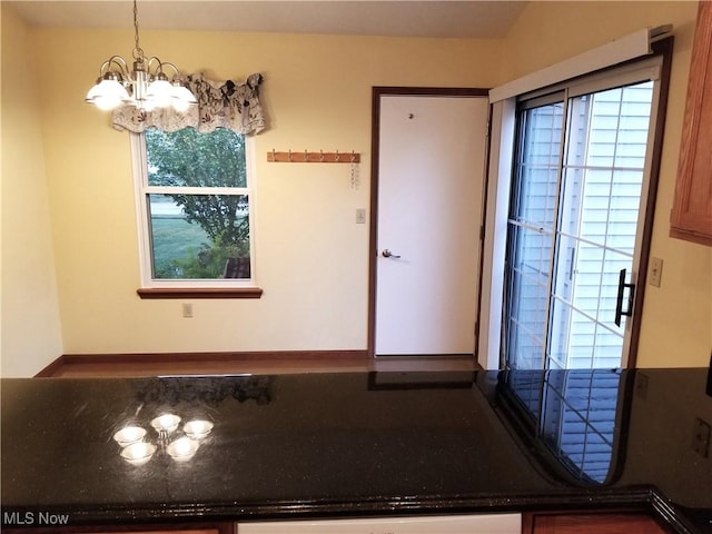 unfurnished dining area with a chandelier and a healthy amount of sunlight