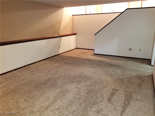 unfurnished room featuring light carpet