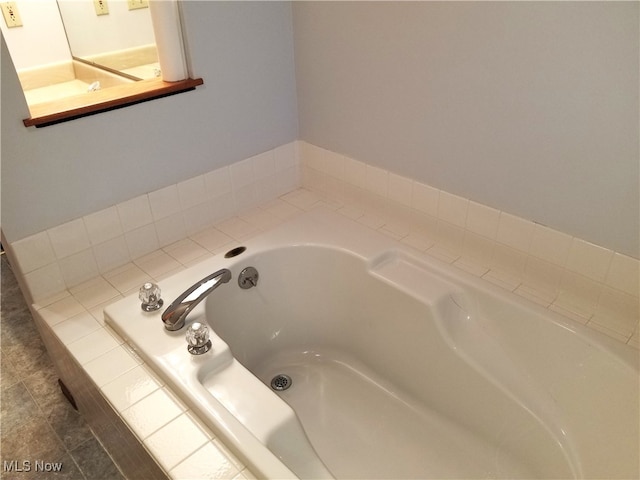 bathroom featuring tiled bath