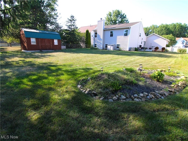 view of yard with a storage shed and central air condition unit