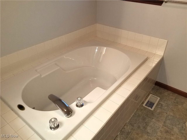 interior details with tile patterned floors and tiled tub