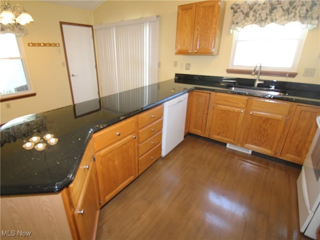 kitchen featuring dark hardwood / wood-style flooring, white dishwasher, kitchen peninsula, sink, and decorative light fixtures