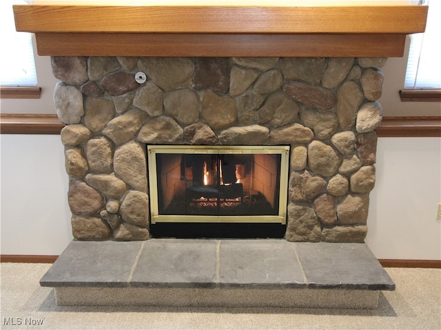 details featuring a fireplace and carpet flooring