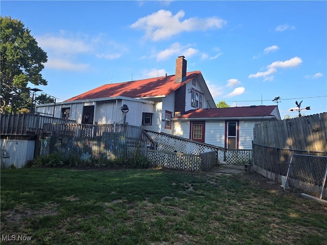 back of house with a lawn