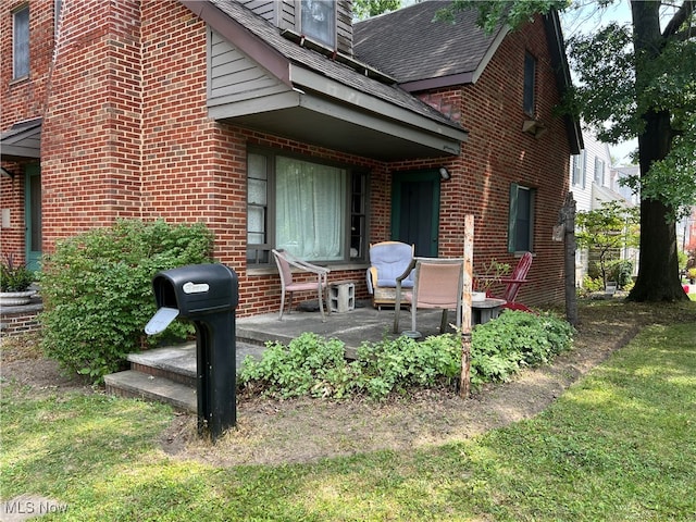 back of property with a patio area and a yard