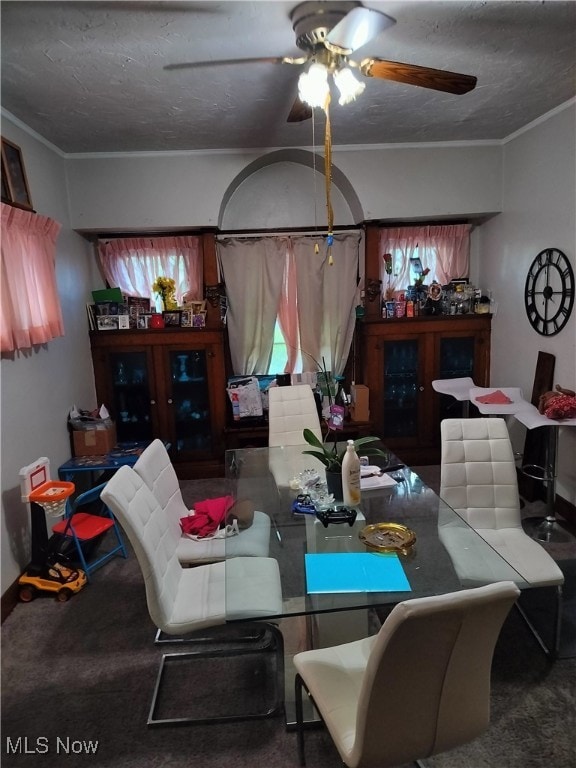 dining room with ceiling fan and crown molding