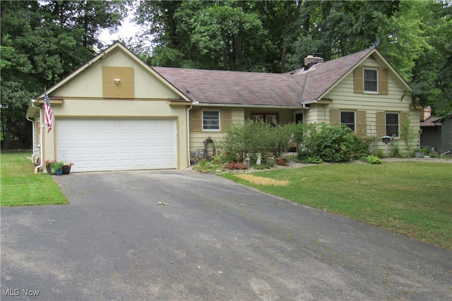 view of front of home with a garage and a front lawn