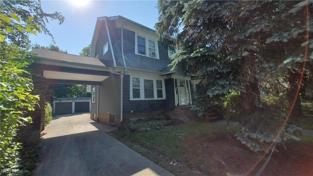 view of front of home with an outdoor structure, a garage, and a carport