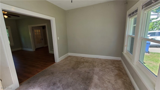 carpeted spare room featuring ceiling fan