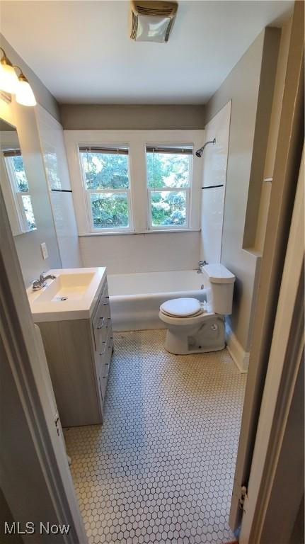 bathroom featuring tub / shower combination, vanity, and toilet