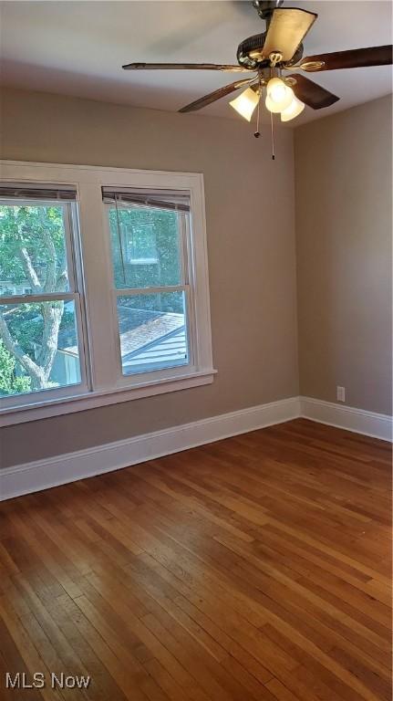 empty room featuring hardwood / wood-style flooring and ceiling fan