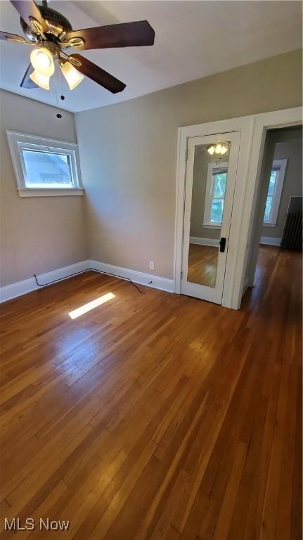 spare room featuring ceiling fan and dark hardwood / wood-style floors