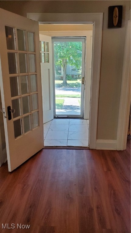 doorway to outside with wood-type flooring