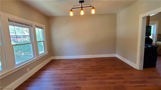 empty room with dark hardwood / wood-style flooring