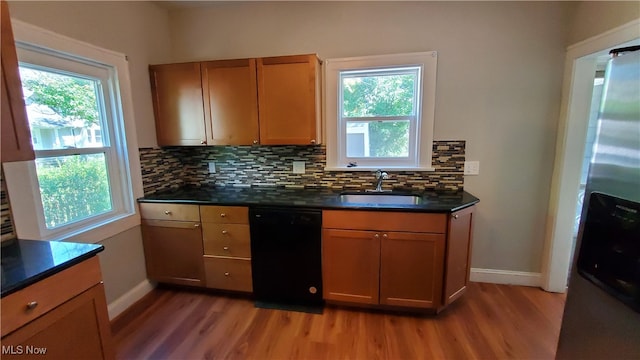 kitchen with black dishwasher, plenty of natural light, and sink