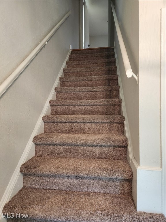 stairs featuring baseboards