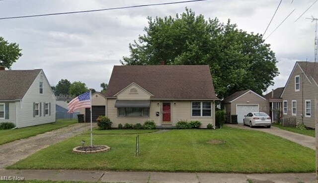 view of front of property featuring a garage and a front lawn