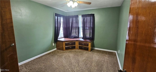 interior space with carpet floors, baseboards, and a ceiling fan