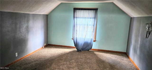 bonus room with carpet floors, vaulted ceiling, and baseboards