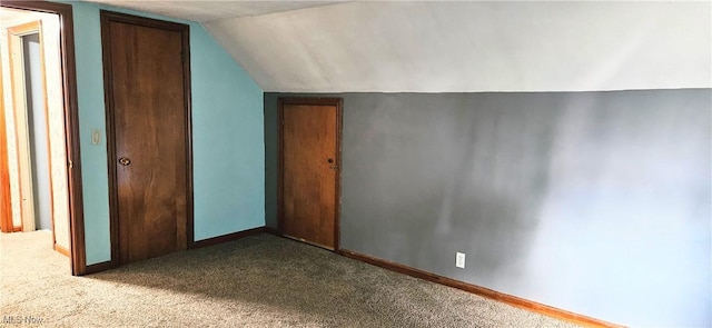 bonus room featuring lofted ceiling, baseboards, and light colored carpet