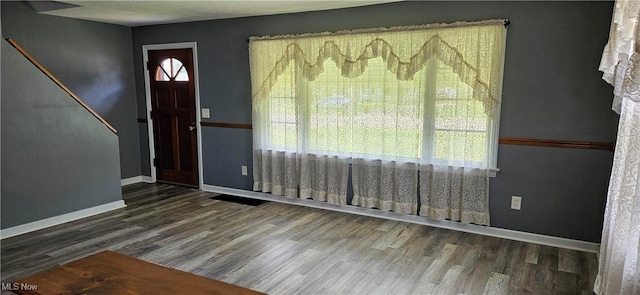 foyer featuring dark wood-style floors and baseboards