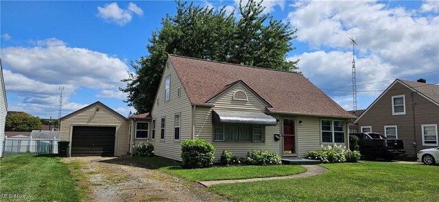 bungalow featuring a garage and a front lawn