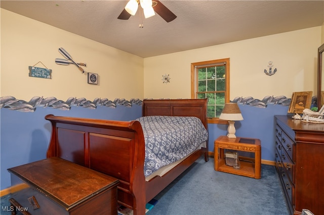 bedroom with ceiling fan, carpet flooring, and a textured ceiling