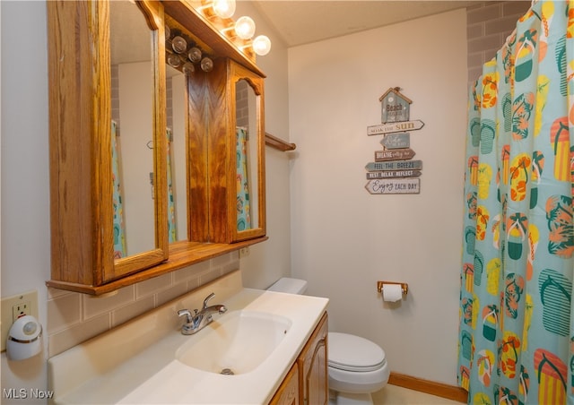 bathroom featuring toilet and vanity