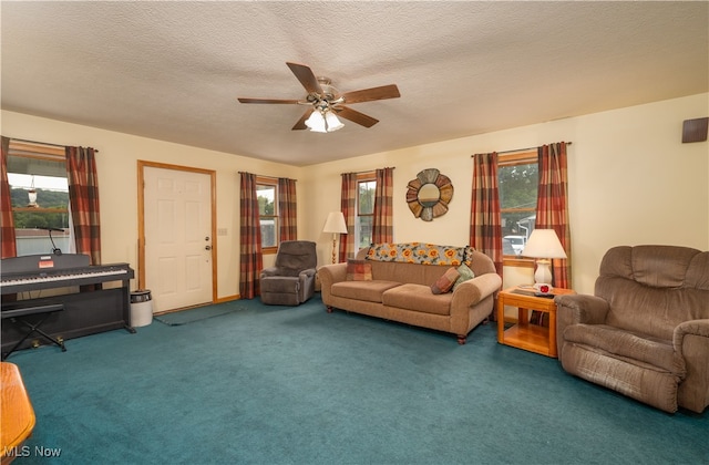 carpeted living room with ceiling fan and a textured ceiling