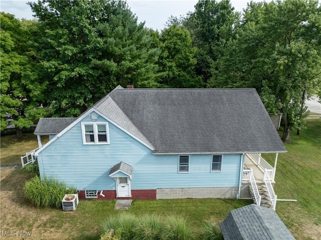 rear view of house featuring a yard