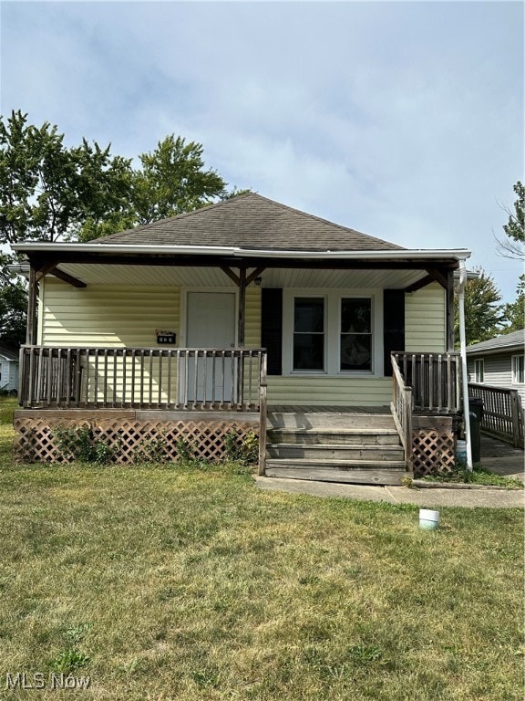 view of front of property with a front lawn and a wooden deck